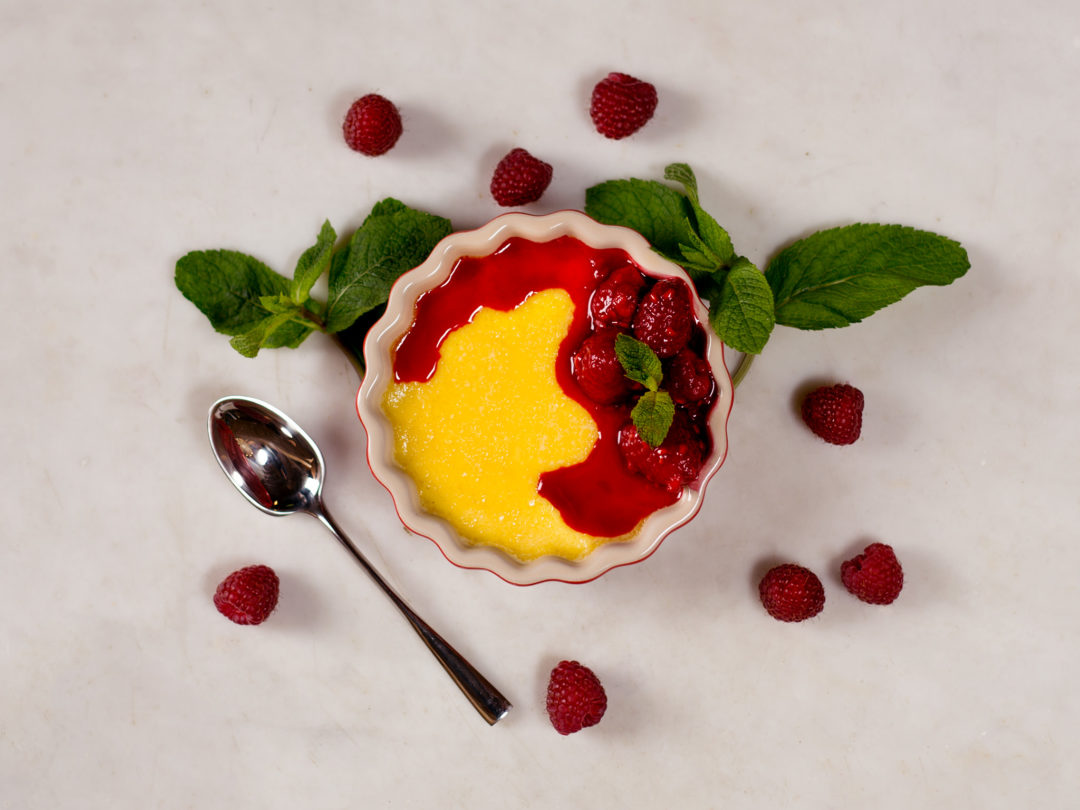 Baked vanilla pudding with hot raspberries