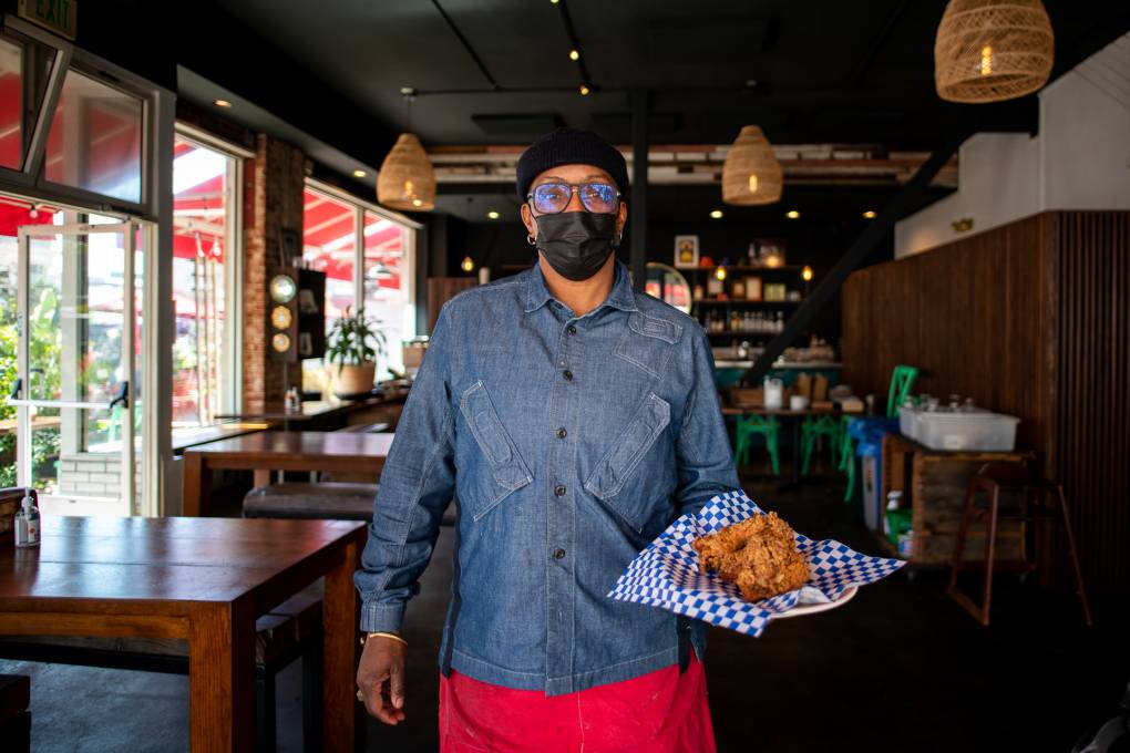 Miss Ollie’s Legendary Chef Bids Farewell With One Final Dinner in Oakland Wearing a face mask, chef Sarah Kirnon holds a plate of fried chicken at Miss Ollie's, her Old Oakland restaurant.