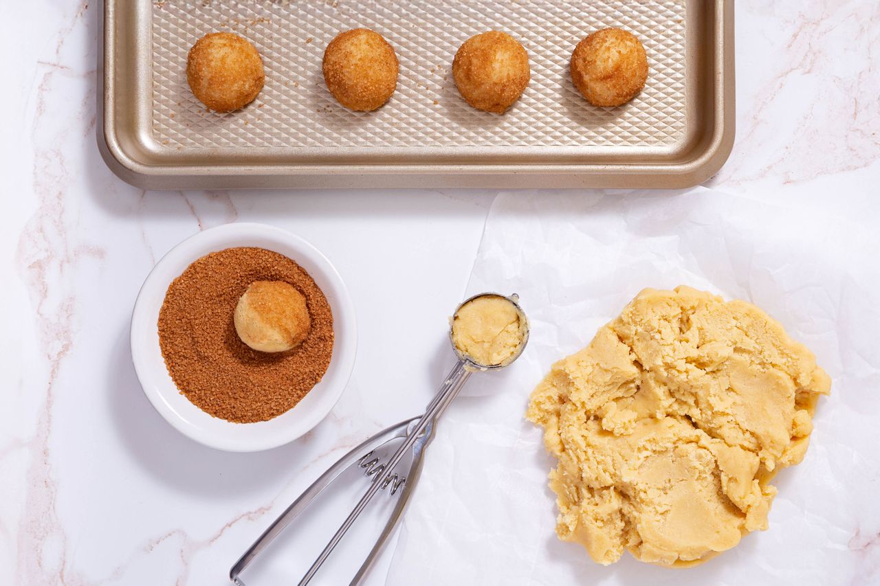 Metal scoops help produce uniform batches of cookies that bake evenly.Credit: LindasPhotography / Getty Images
