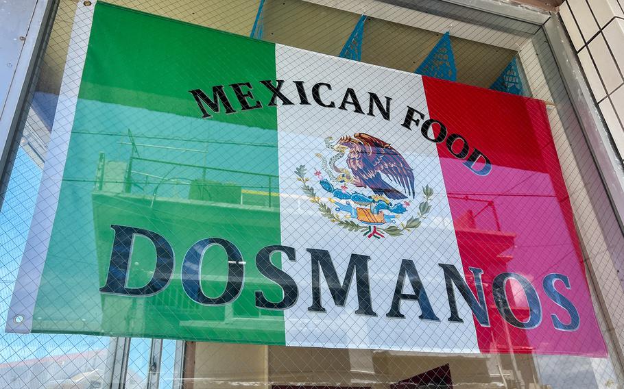 A colorful flag in a window.