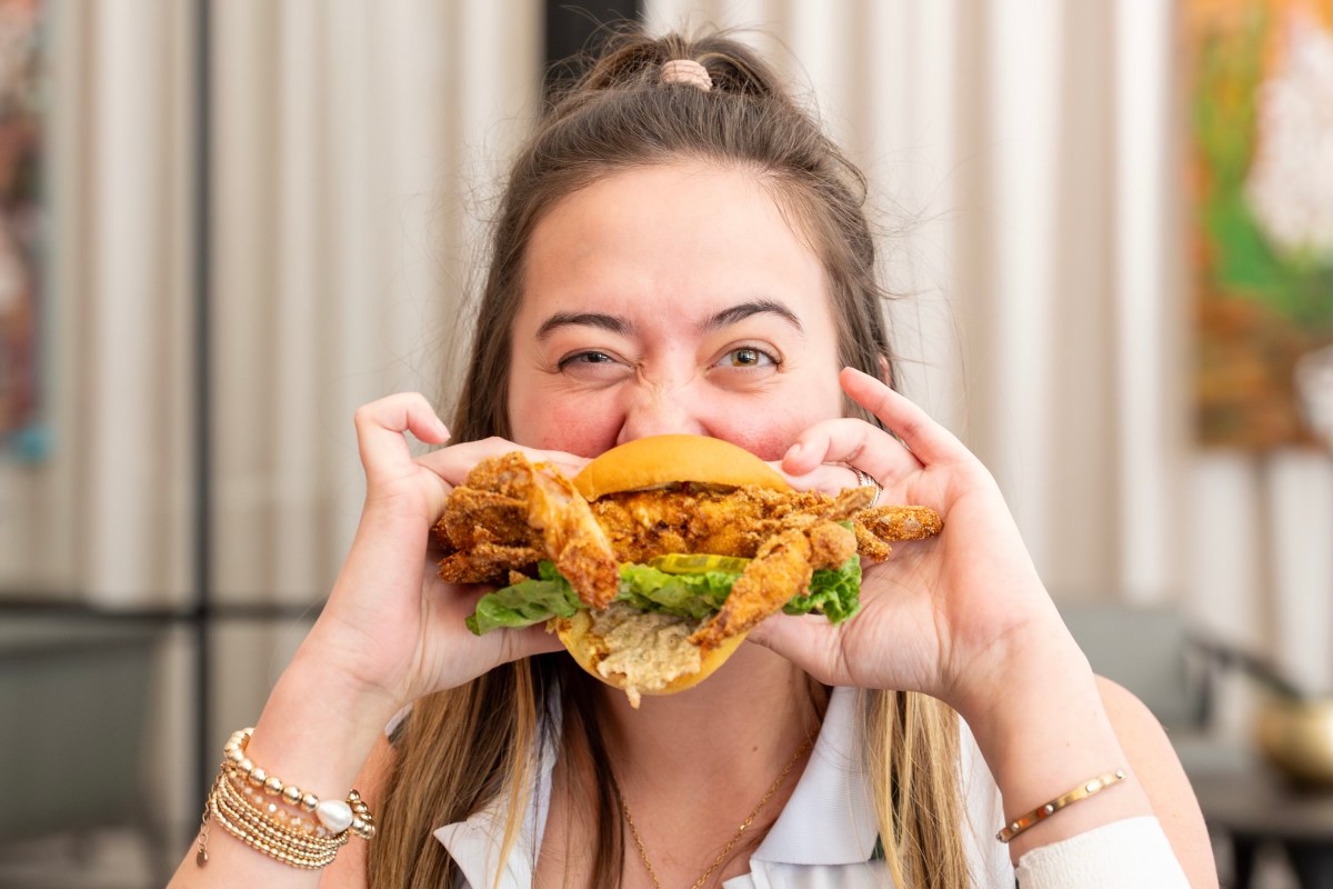 person eating a crab sandwich 