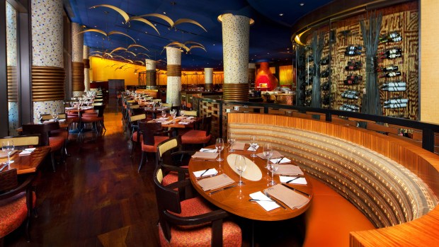The dining room at Jiko - The Cooking Place, located inside Disney's Animal Kingdom lodge serves up delights from its crackling, wood-burning ovens and features an award-winning South African wine list. (Photo courtesy ©2026 Disney. All rights reserved.)