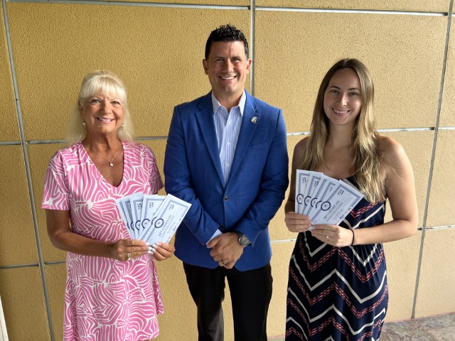 Lucy Nicandri, Casey Gonzmart Jr. and Lisa Bear with Community Harvest materials