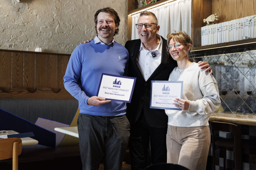 Michael Muser stands with chef-owner David Posey and Chef De Cuisine Tayler Ploshehanski, who are holding up their certificates.