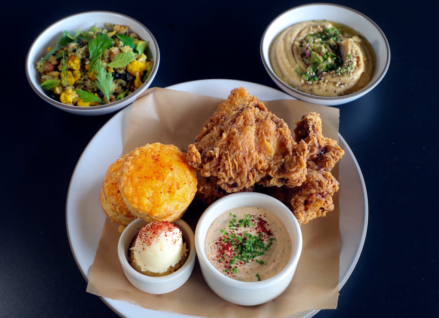 The half fried chicken served with black bean hummus and cauliflower cashew pilaf at Chickadee Restaurant in the Seaport.