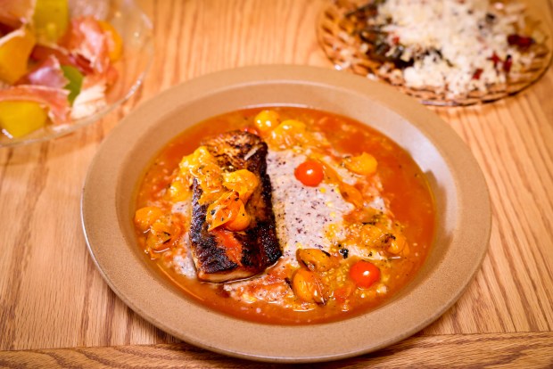 Blackened fish over grits served by chef Geoff Davis at Burdell, a new Soul Food restaurant in the Temescal neighborhood of Oakland, Calif., on Thursday, Sept. 28, 2023. (Ray Chavez/Bay Area News Group)
