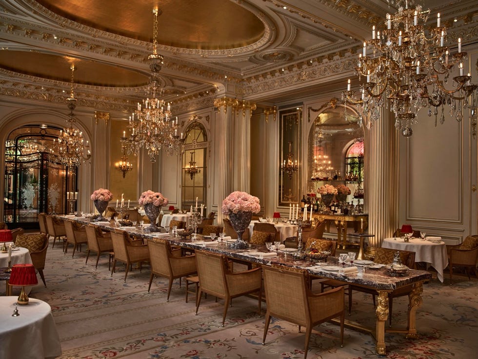 Elegant dining room with chandeliers, floral arrangements, and beautifully set tables in a luxurious atmosphere. Elegant dining room with chandeliers, floral arrangements, and beautifully set tables in a luxurious atmosphere.