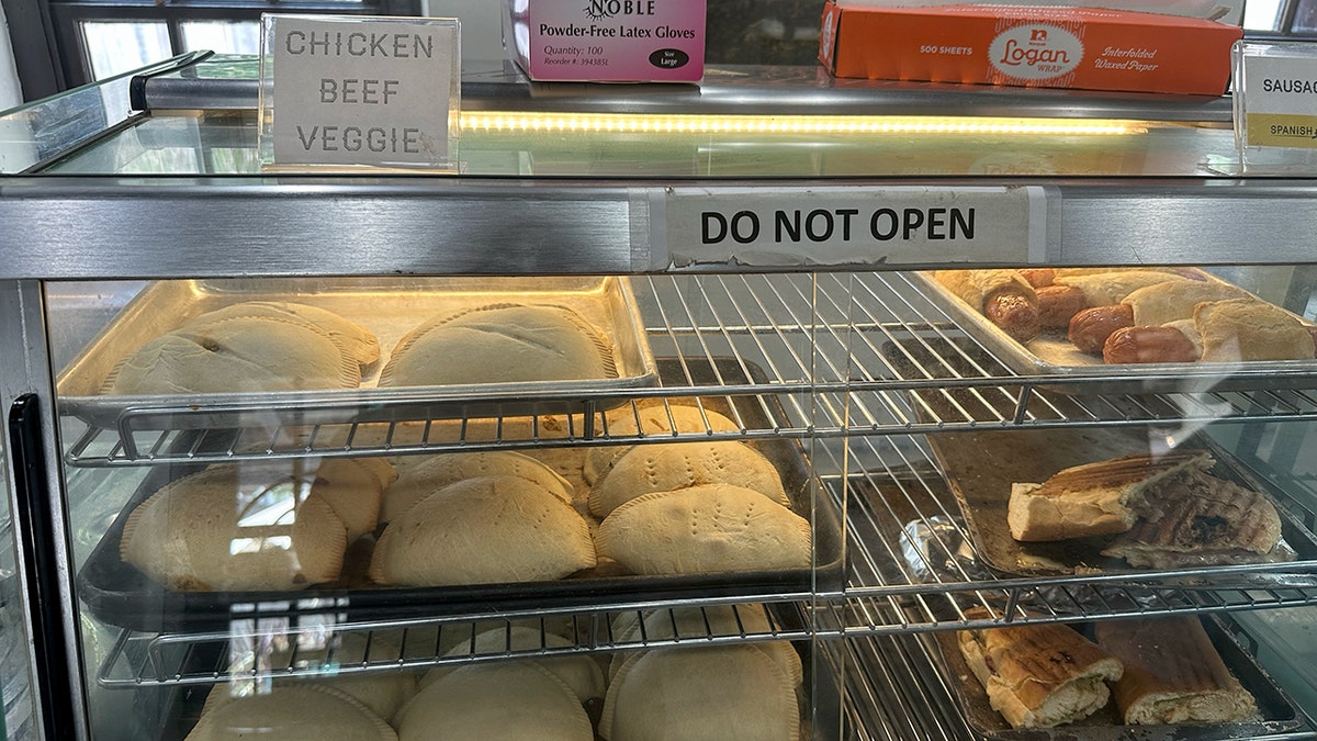 Chicken, beef and veggie empanadas are shown on display.