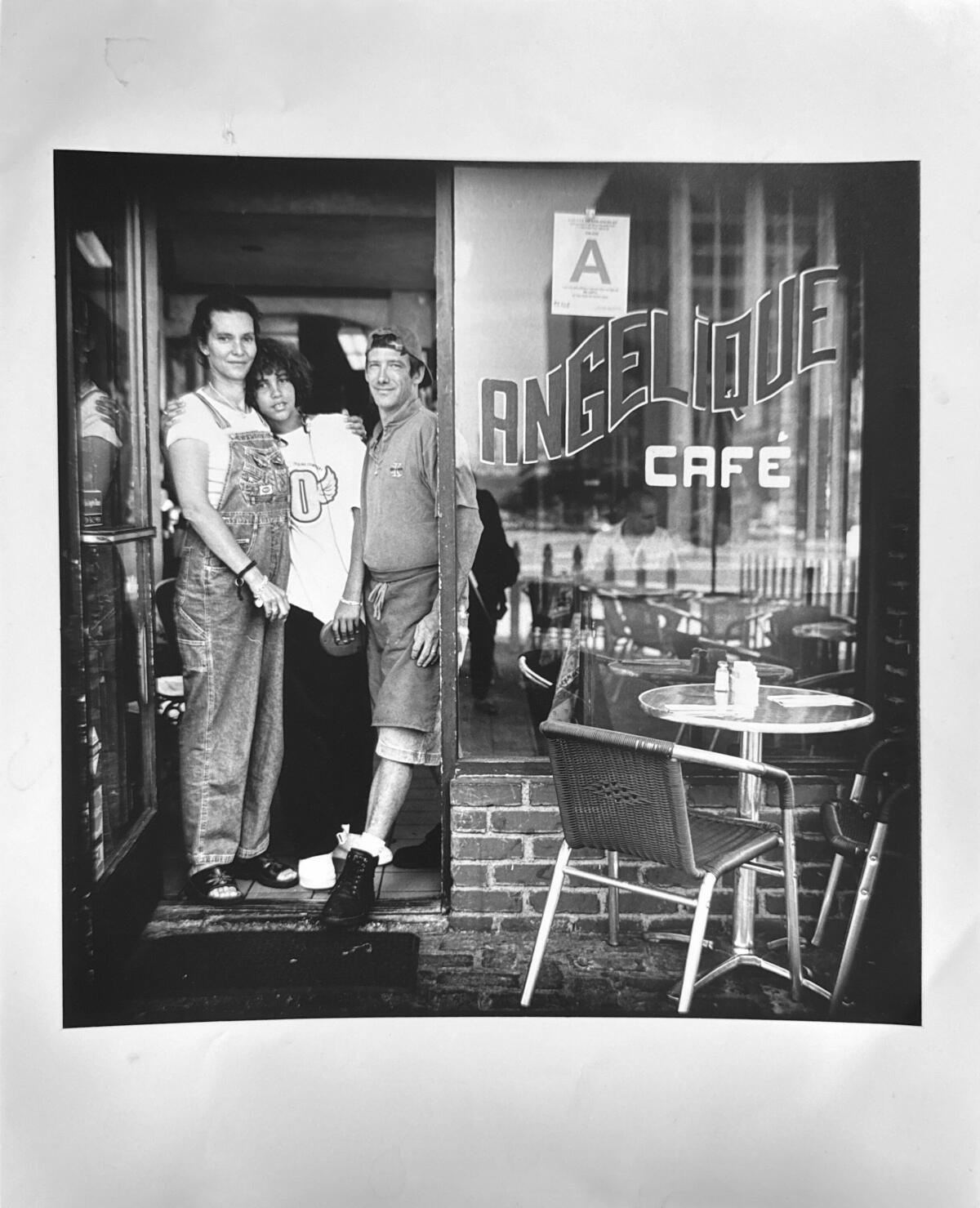 Florence Fall, a young Jeremy Fall and Bruno Herve-Commereuc stand at Fall's former family cafe