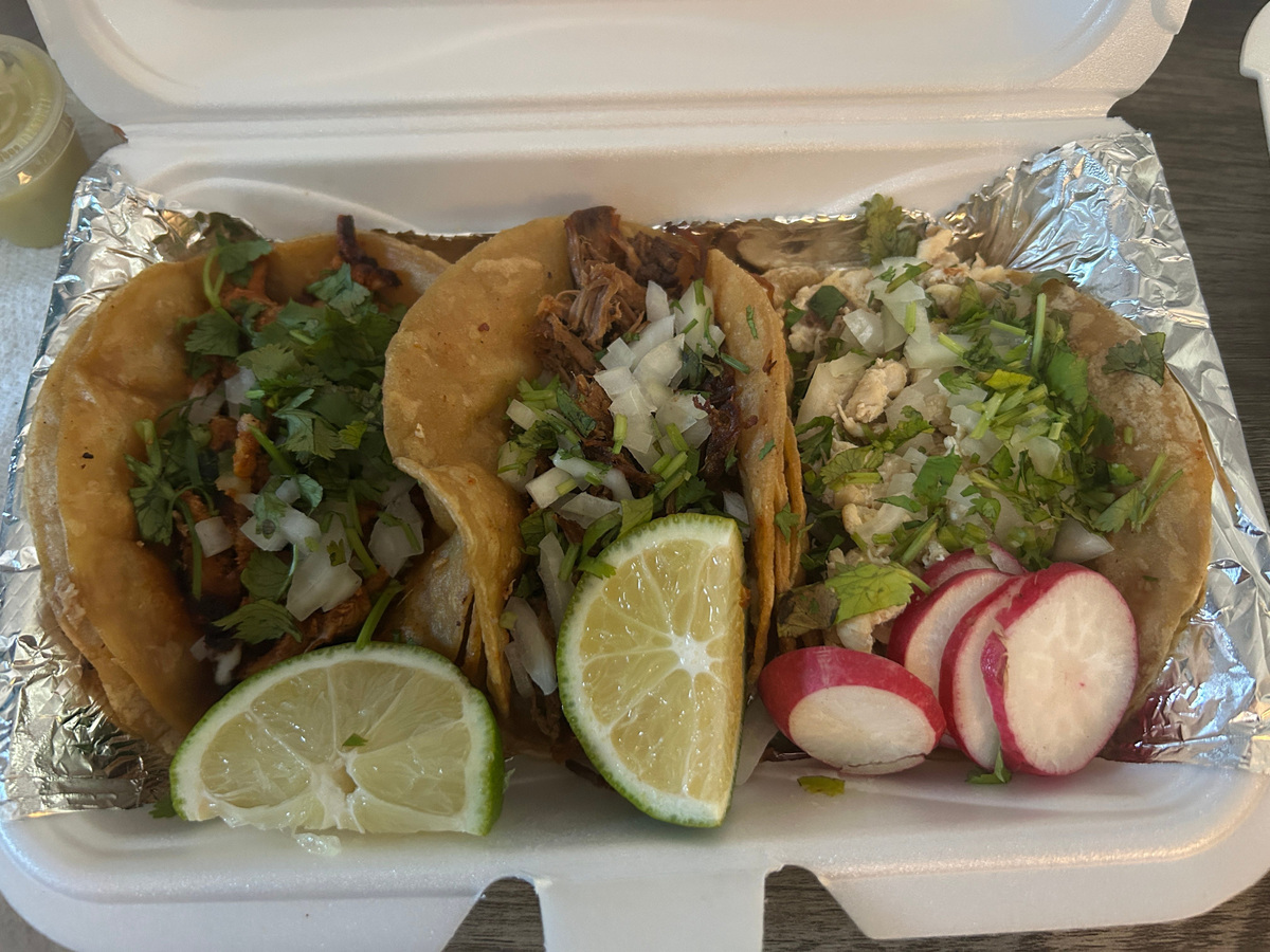 Three street tacos from Tacos El Mandi, a food truck that offers Mexican cuisine throughout the area of the South Akron neighborhood.