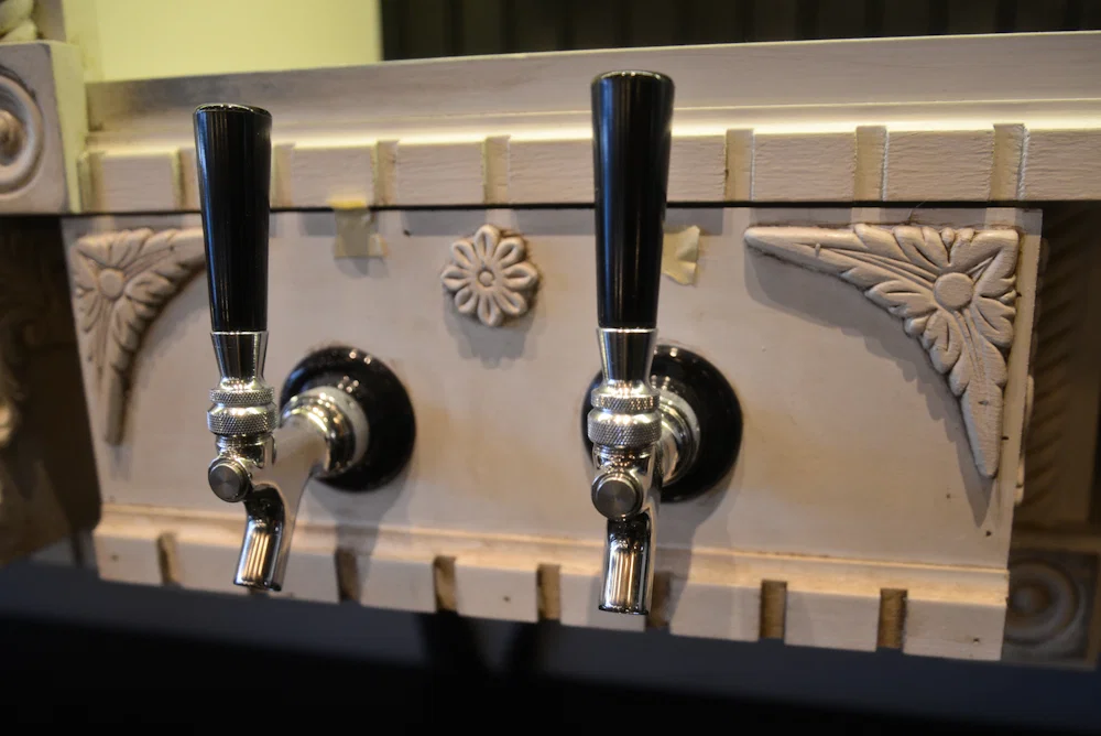 Several beer taps line the bar, including these elegant handles.