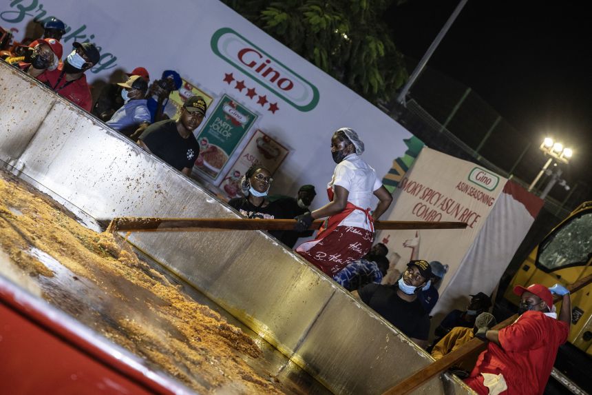Nigerian chef Hilda Baci stirs rice in a giant pot during an attempt to break the world record for the largest pot of Jollof rice in Lagos, on September 12, 2025.