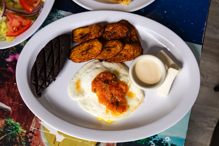 Encuentro Latino's Guatemalan breakfast features deep-fried plantains, two eggs topped with chrimol, queso fresco and cream, and refried beans - which folks often mistake for chocolate. The black beans have been blended and reshaped into a oblong patty, with a diagonal grid pattern across the top.