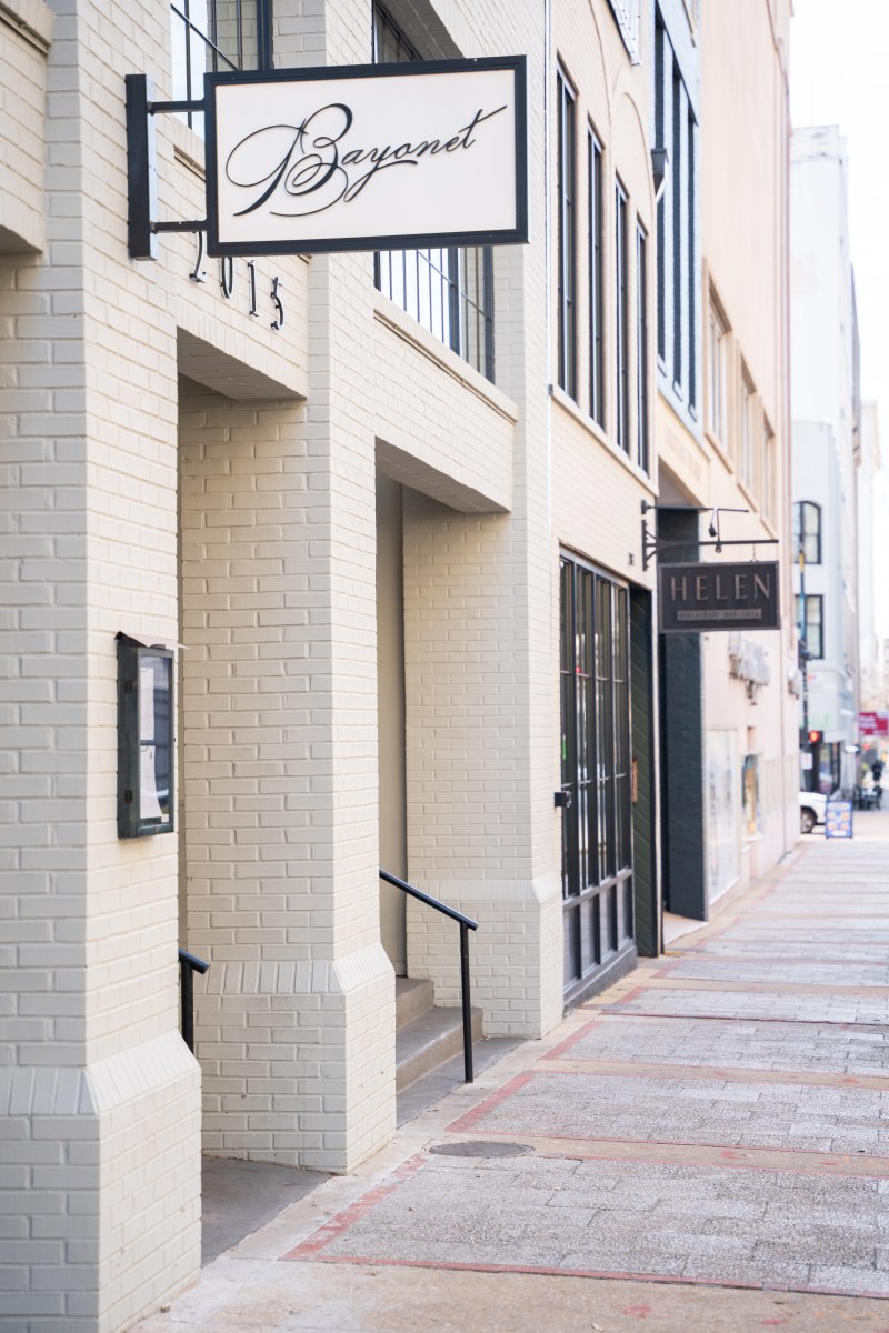 Exterior of Bayonet restaurant at 2015, with Helen restaurant visible next door along a downtown sidewalk