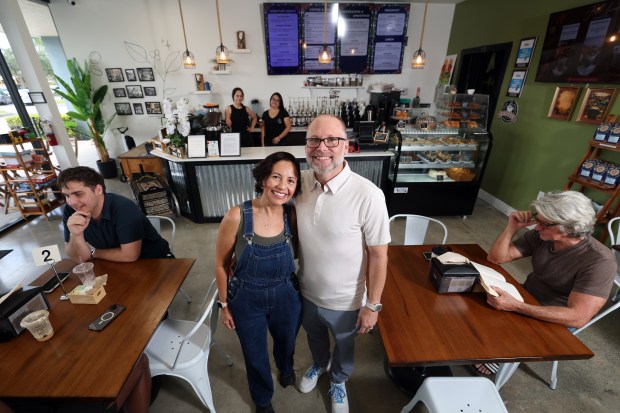 Owners Gabriela and Jeff Marder, with employees Natasha Villegas, left, and Maria Briceno behind at the counter, are shown at Tarrazu Coffee Co. in Coconut Creek on Monday, Sept. 28, 2026. The family-owned shop has won best coffee in the Sun Sentinel's Best of South Florida Dining series. (Amy Beth Bennett/South Florida Sun Sentinel)
