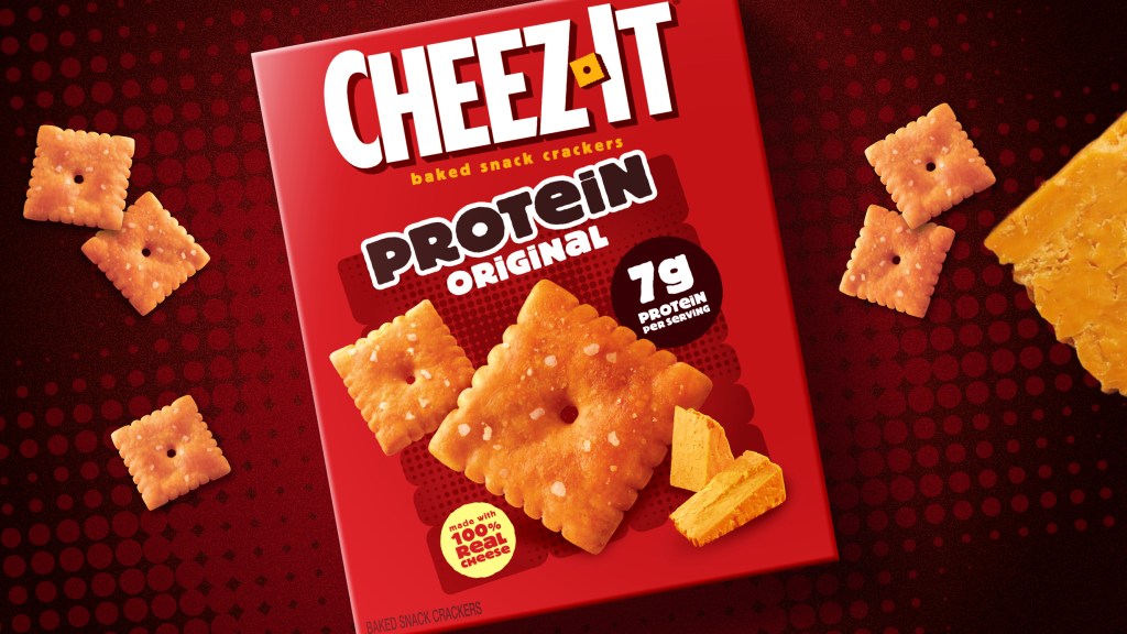 Illustration of a box of Cheez-It Protein Original crackers with loose crackers and cheese on a red dotted background.