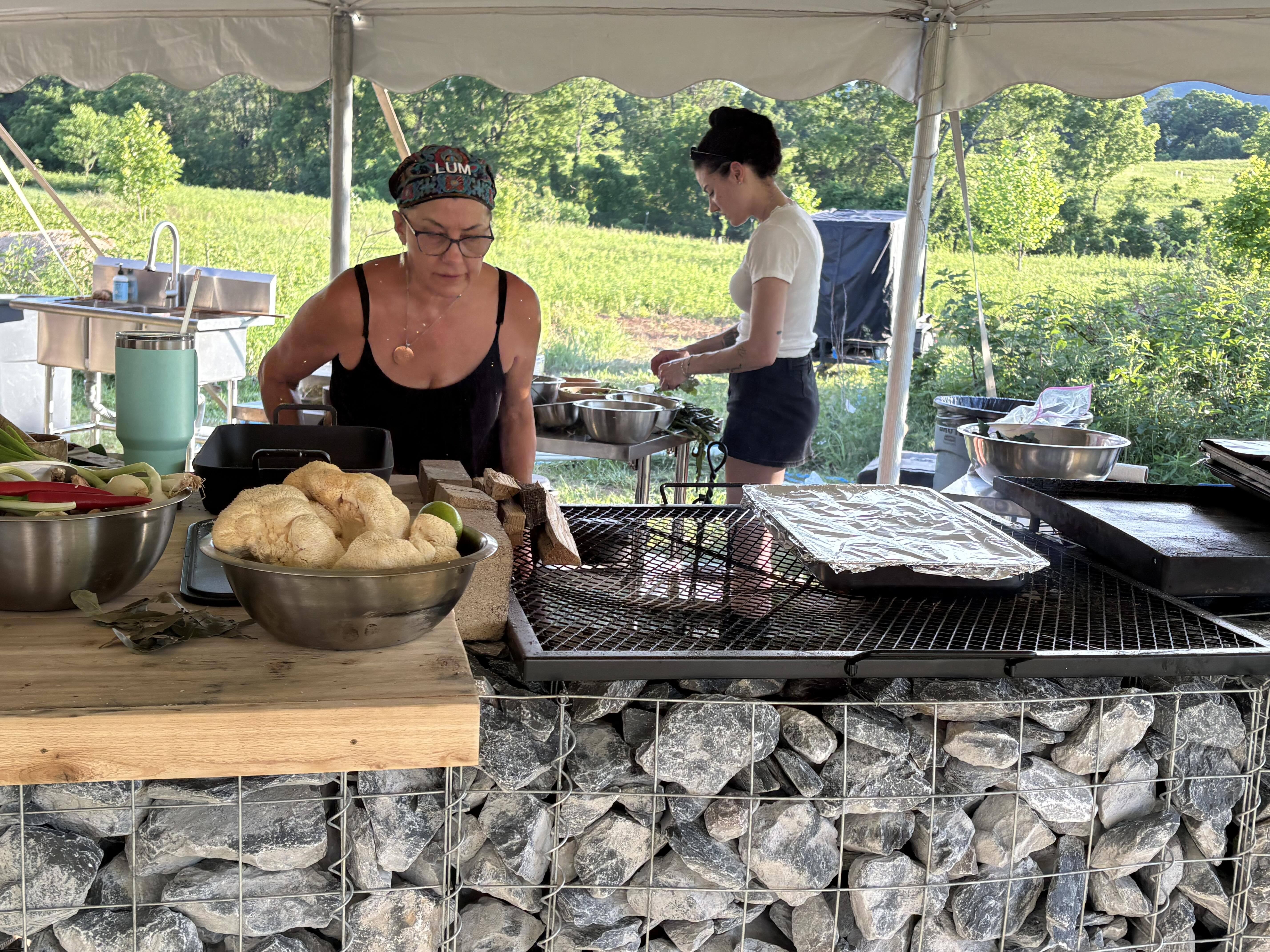 Chef René Locklear White prepares rainbow trout with her granddaughter during the indigenous food contest at the Forest, Food and Fire Ecological Summit on Saturday, June 13, 2026, at the REED Center for Ecosystem Reintegration in Middletown, Maryland.