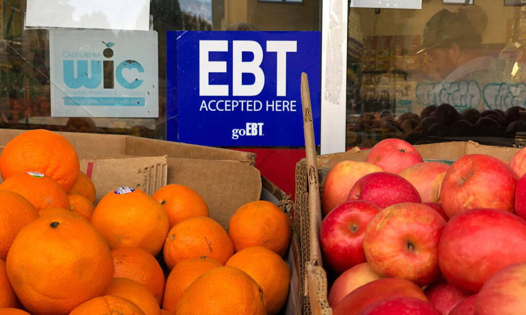 Missouri adds new paperwork requirements to food assistance as federal penalties loom • Missouri Independent A sign noting the acceptance of electronic benefit transfer cards for food aid is displayed at a grocery store in California. Upcoming shifts in the federal food stamp program are poised to cost states billions of dollars, raising fears that more Americans will lose access to the nation’s largest food assistance program. (Photo by Justin Sullivan/Getty Images)