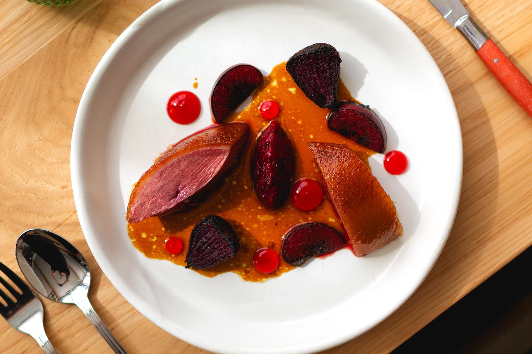 an overhead shot showing a duck dish at firstborn in los angeles