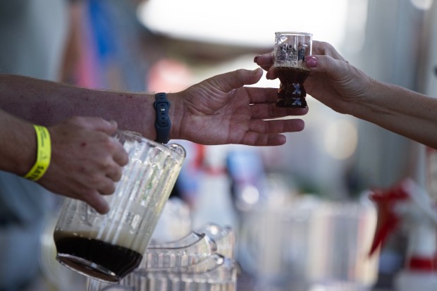 An attendee gets a beer from a vender during the first day of the Great American Beer Festival on Saturday, Oct. 10, 2026, at the Levitt Pavilion Denver in Ruby Hill Park in Denver. (Photo by Timothy Hurst/The Denver Post)