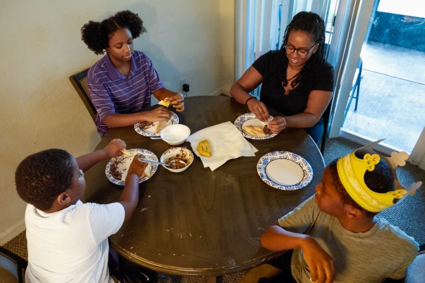 Keaidy Bennett with her daughter, Khole, and two sons, Isaiah and Gabriel, left, have dinner together at their apartment in Winter Park on Wednesday, September 23, 2026. (Rich Pope/Orlando Sentinel)