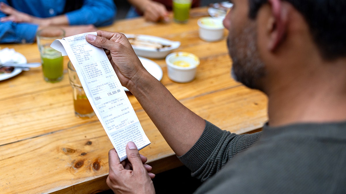 Man looking at receipt