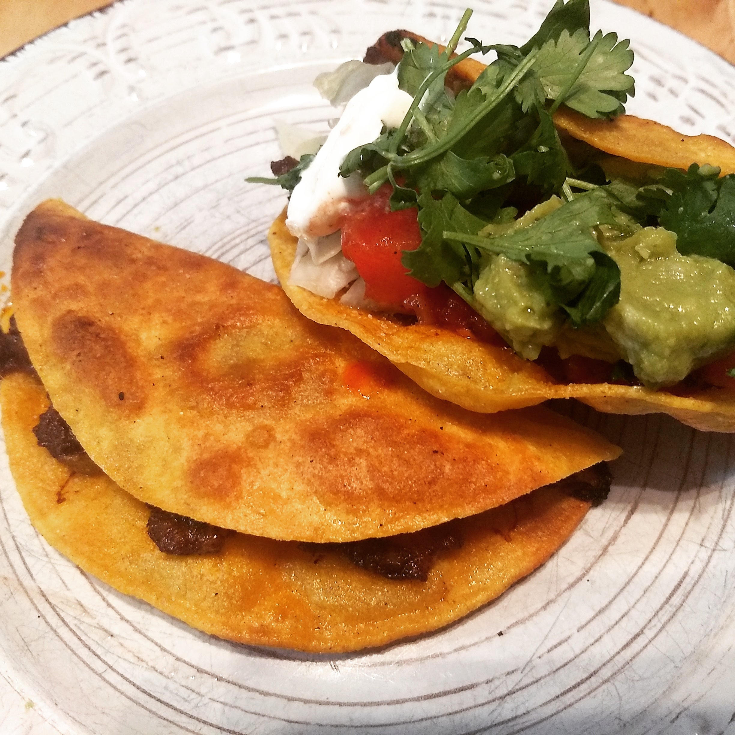 Crispy ground beef tacos before and after accoutrements. Dining and