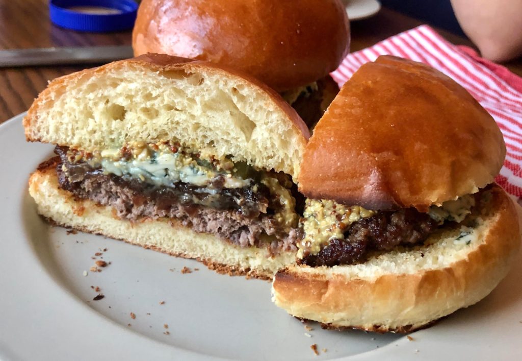 Bleu cheese burger with balsamic onions and mustard on a homemade bun