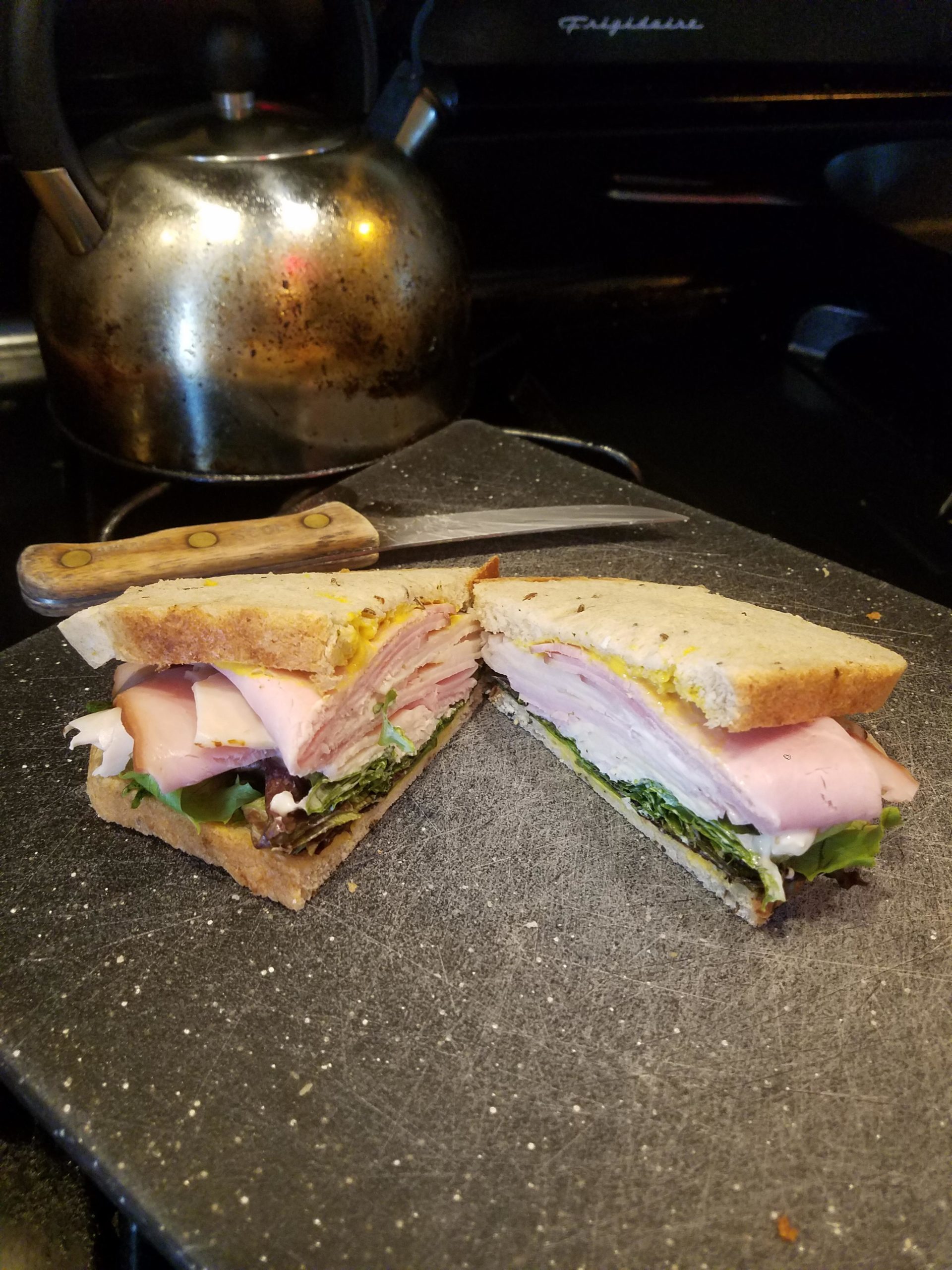 Sloppy ham and turkey with mayo, mustard and spring greens. Al Cohens
