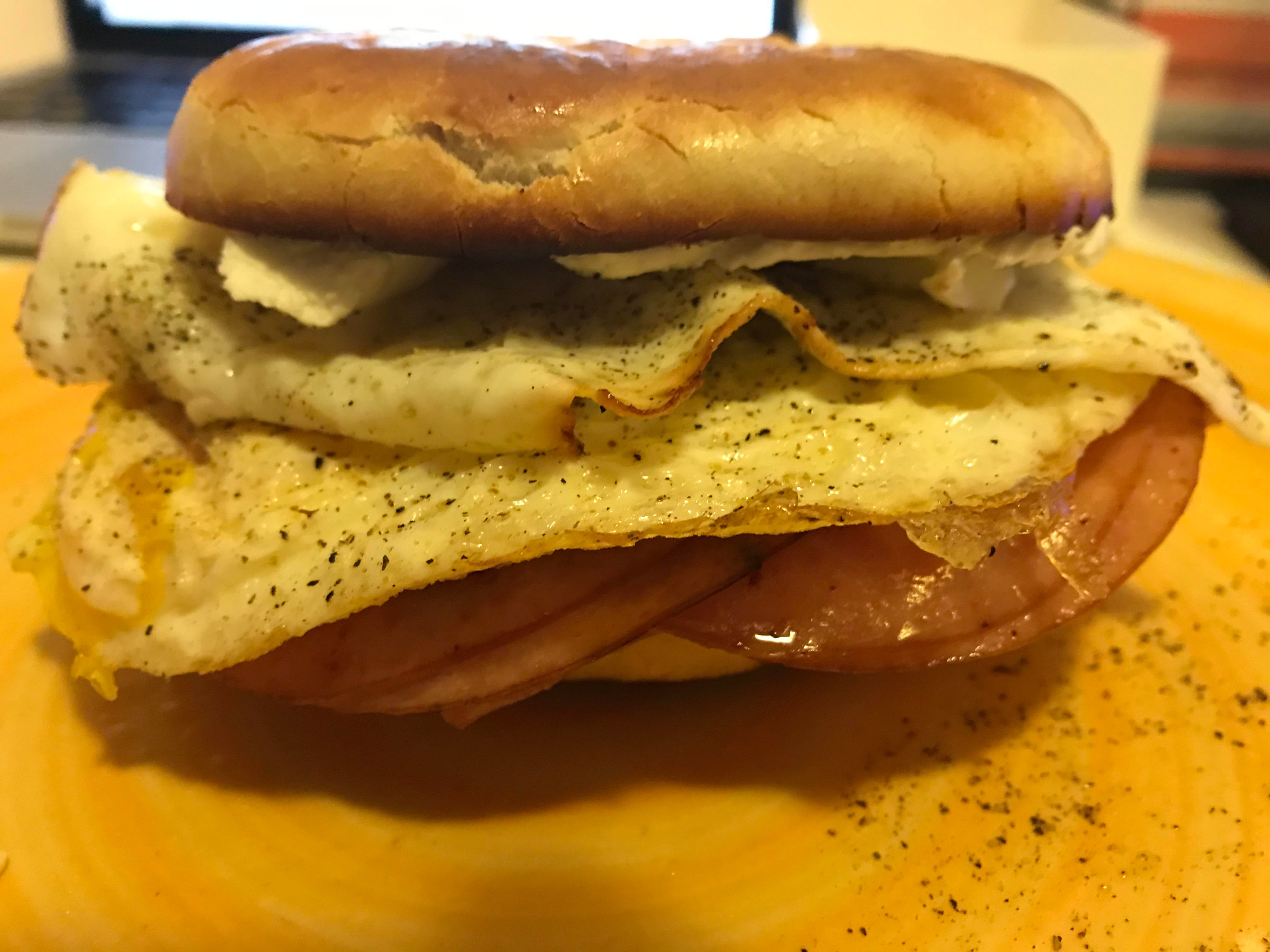 Toasted bagel, cream cheese, two eggs over hard with salt and pepper