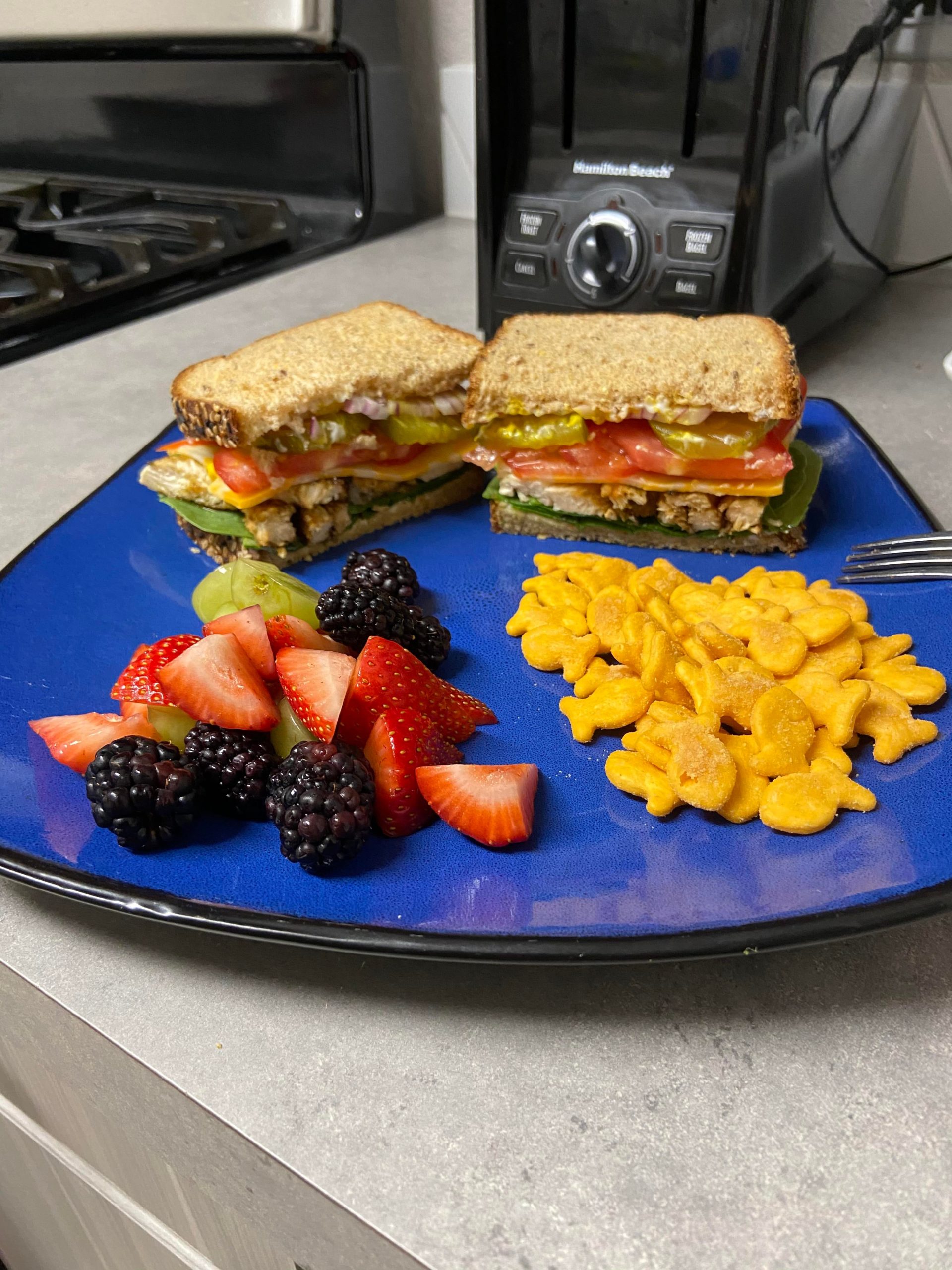 Chicken sammy with a side of fruit salad and flavor blast goldfish. The perfect meal! Dining