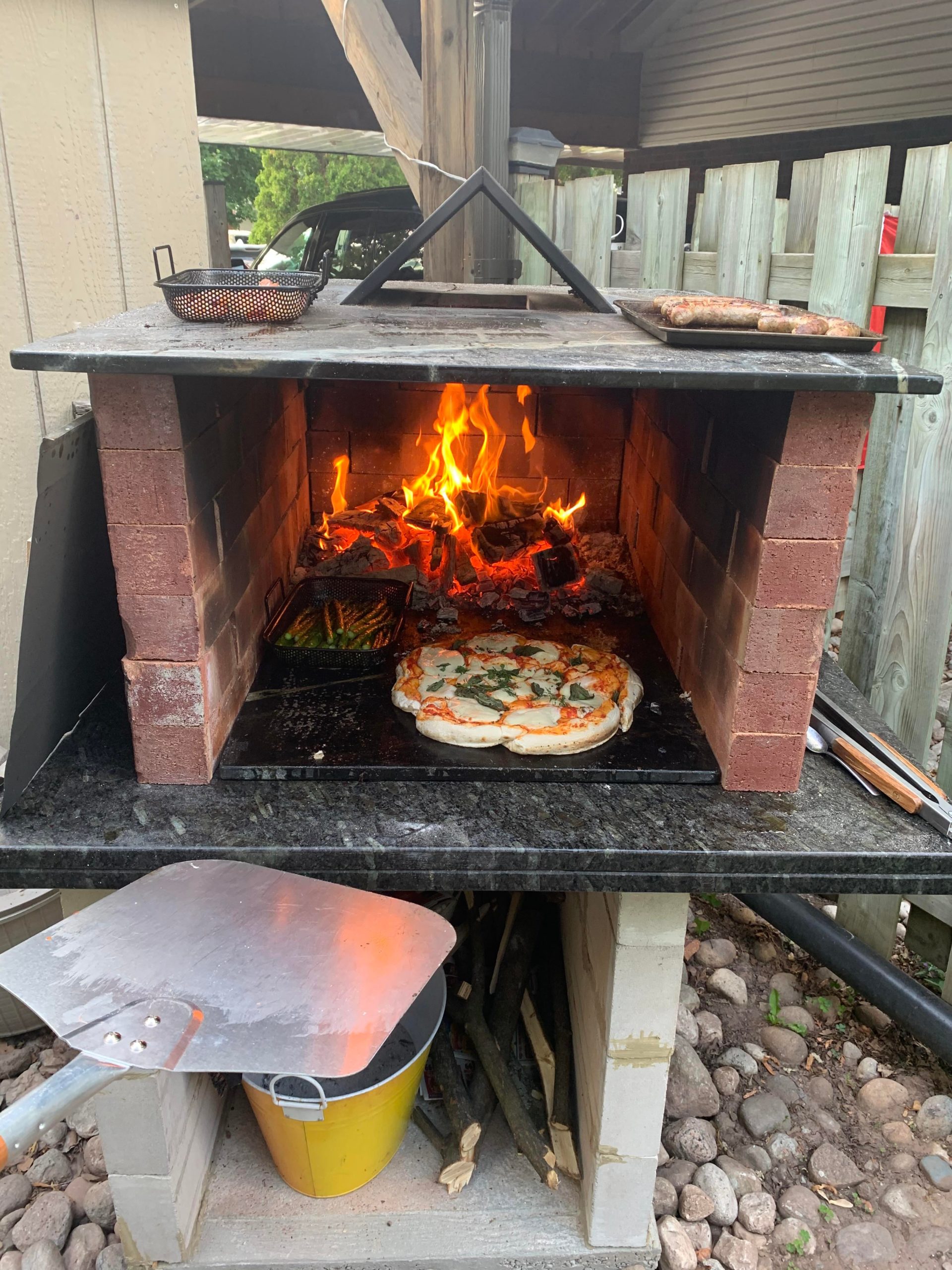 Pizza oven photo (a couple people asked to see it). My dad built it with bricks and granite