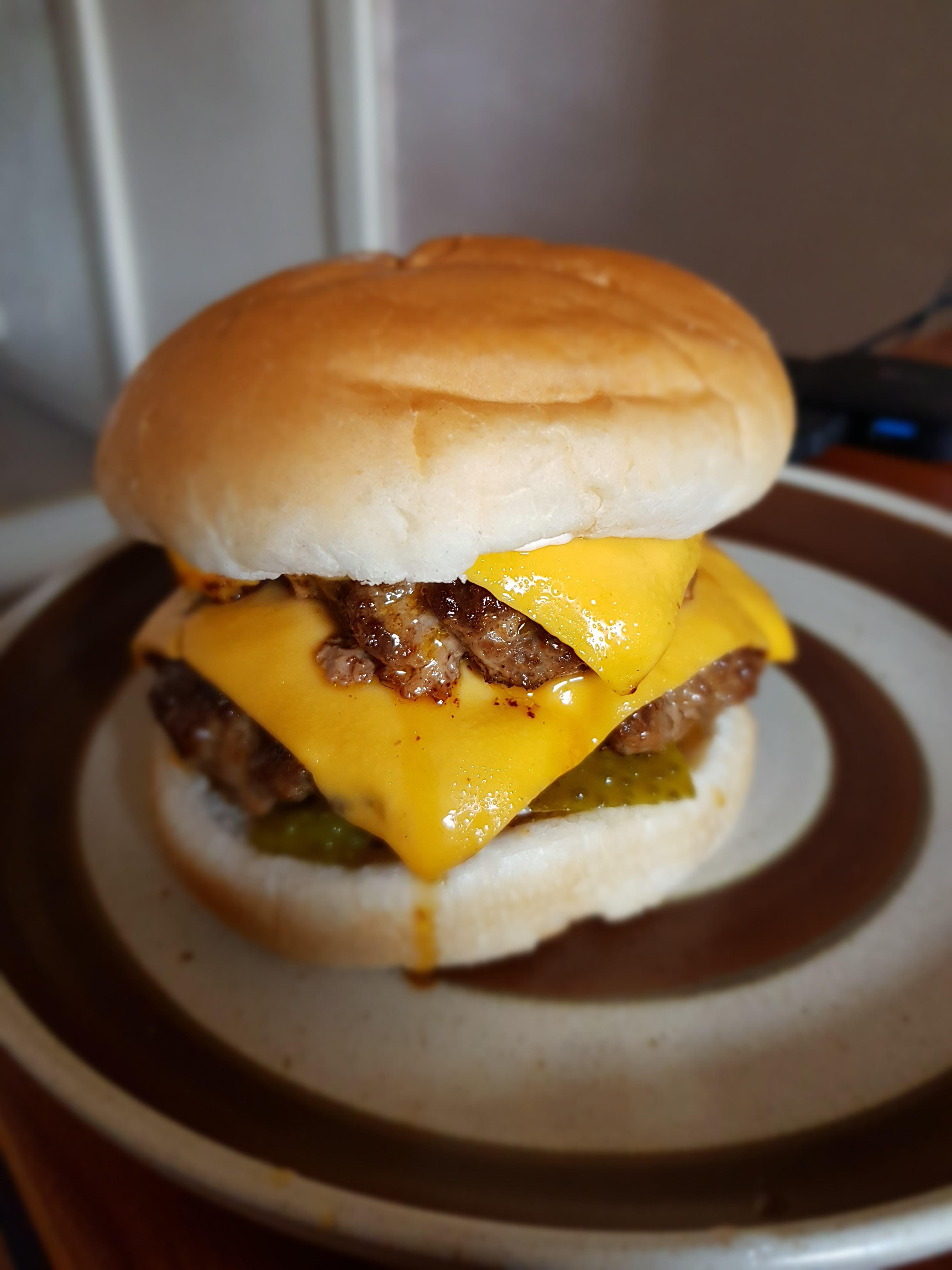 Garlic and smoked paprika burger with cheese and sour pickles Dining