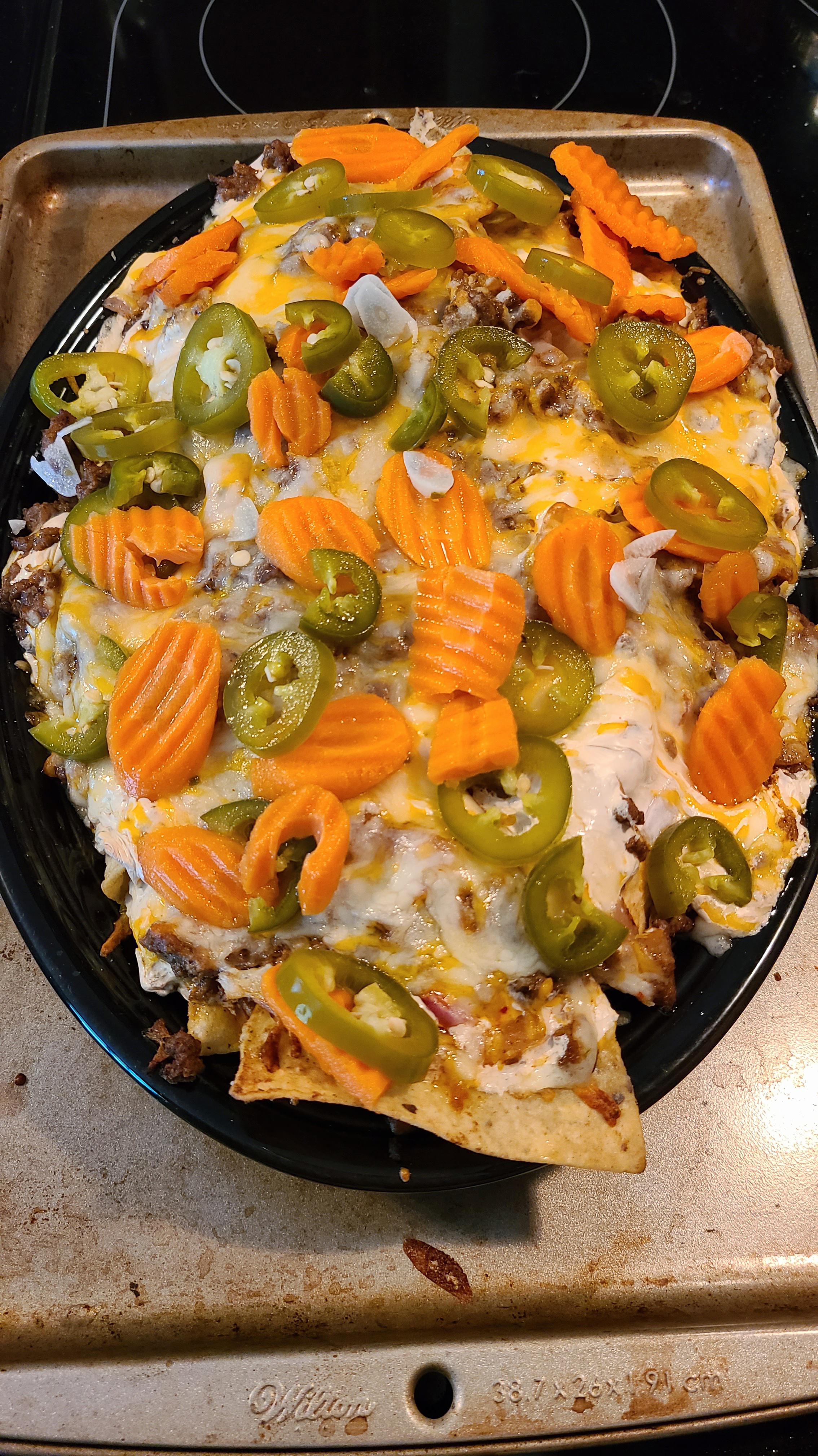 Beef nachos w/ queso, onions, and homemade pickled jalapeños and