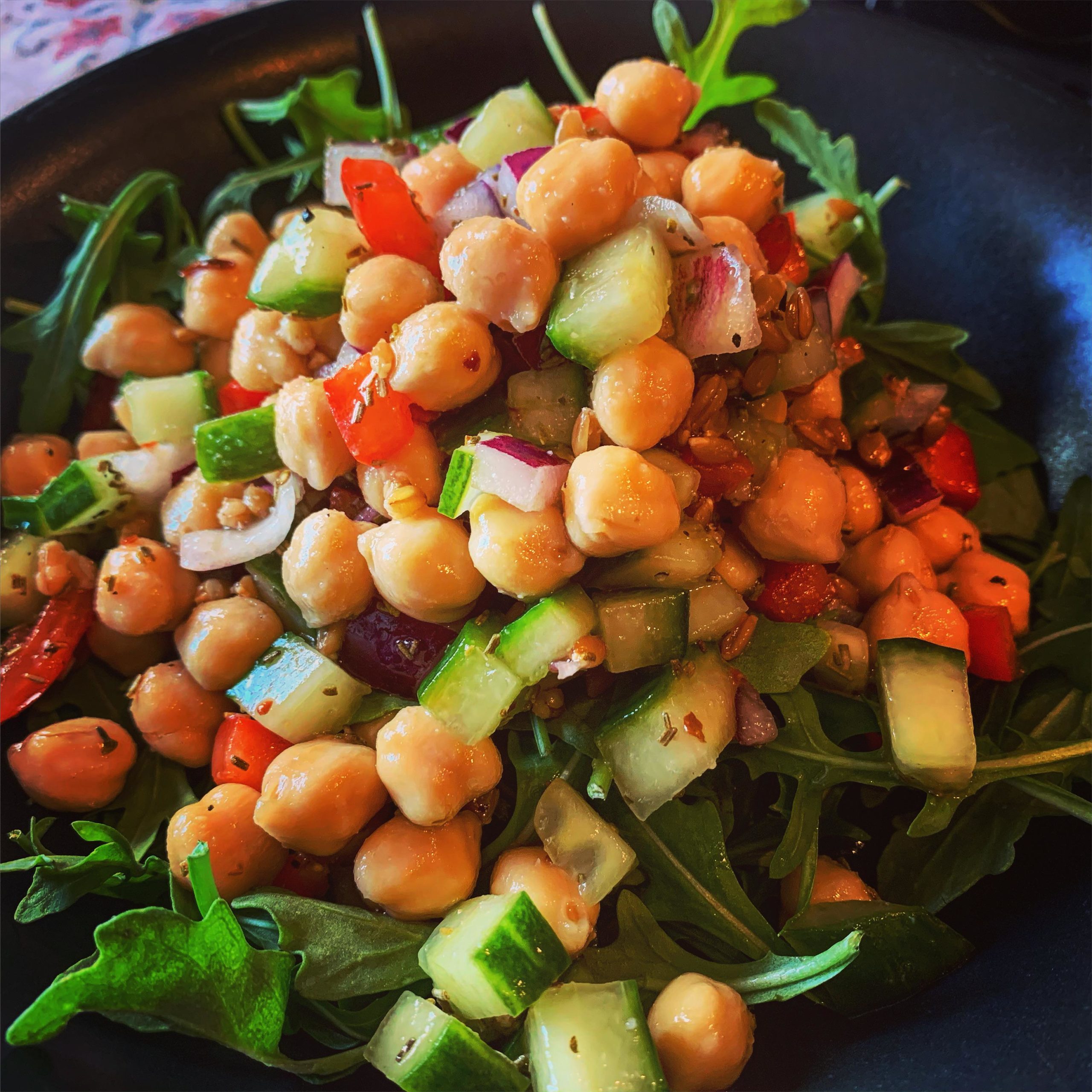 Lunch!! Chickpea salad (chickpeas, onions, peppers, wheat berries, cucumber) over arugula