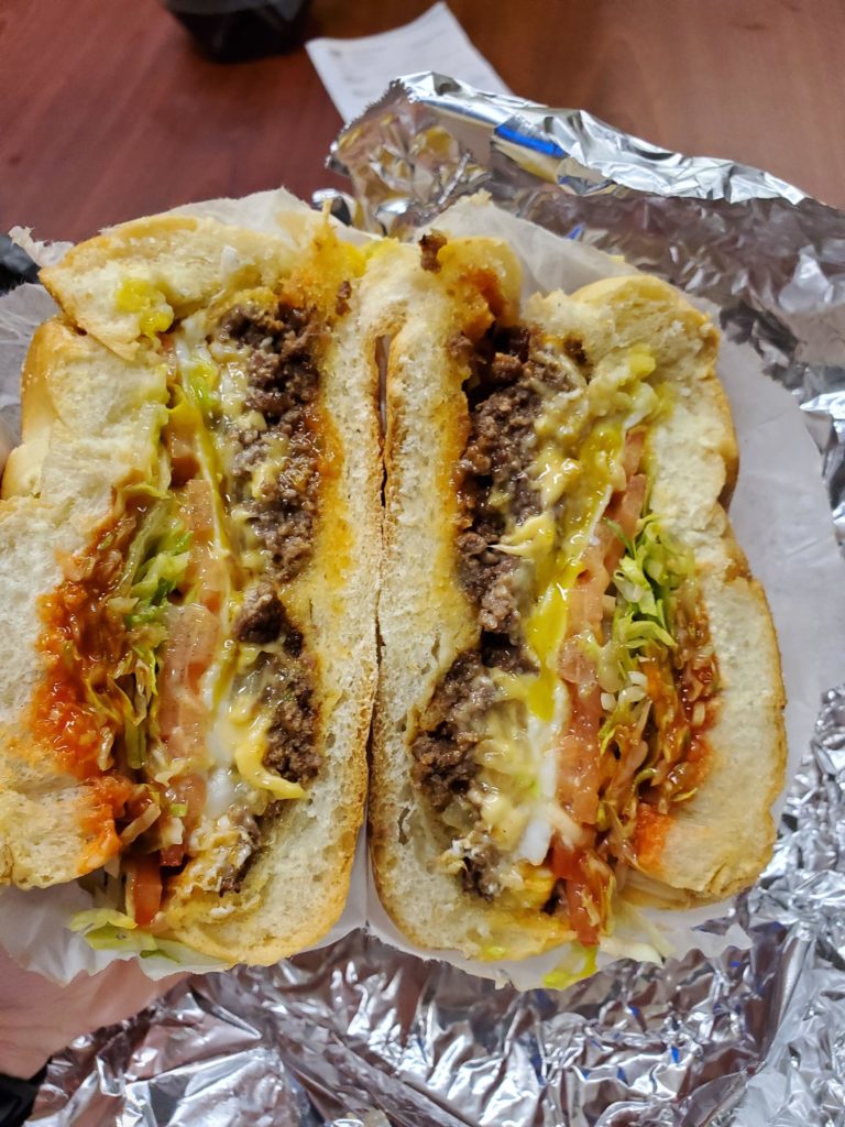 Chopped cheese sandwich with a Sunnyside up egg on top