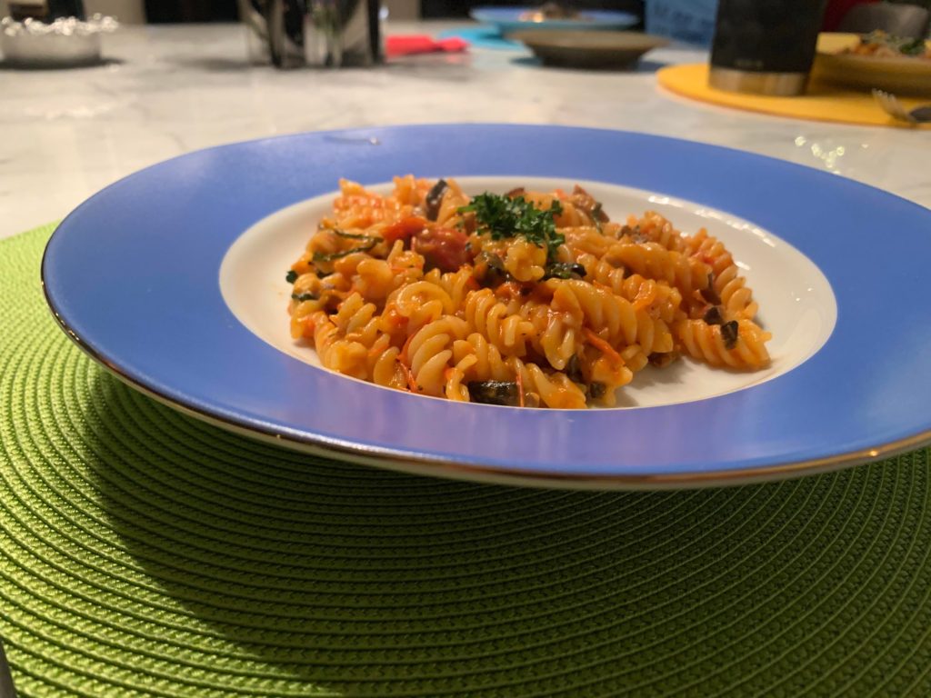 Rotini with tomato-red pepper and mushroom sauce.