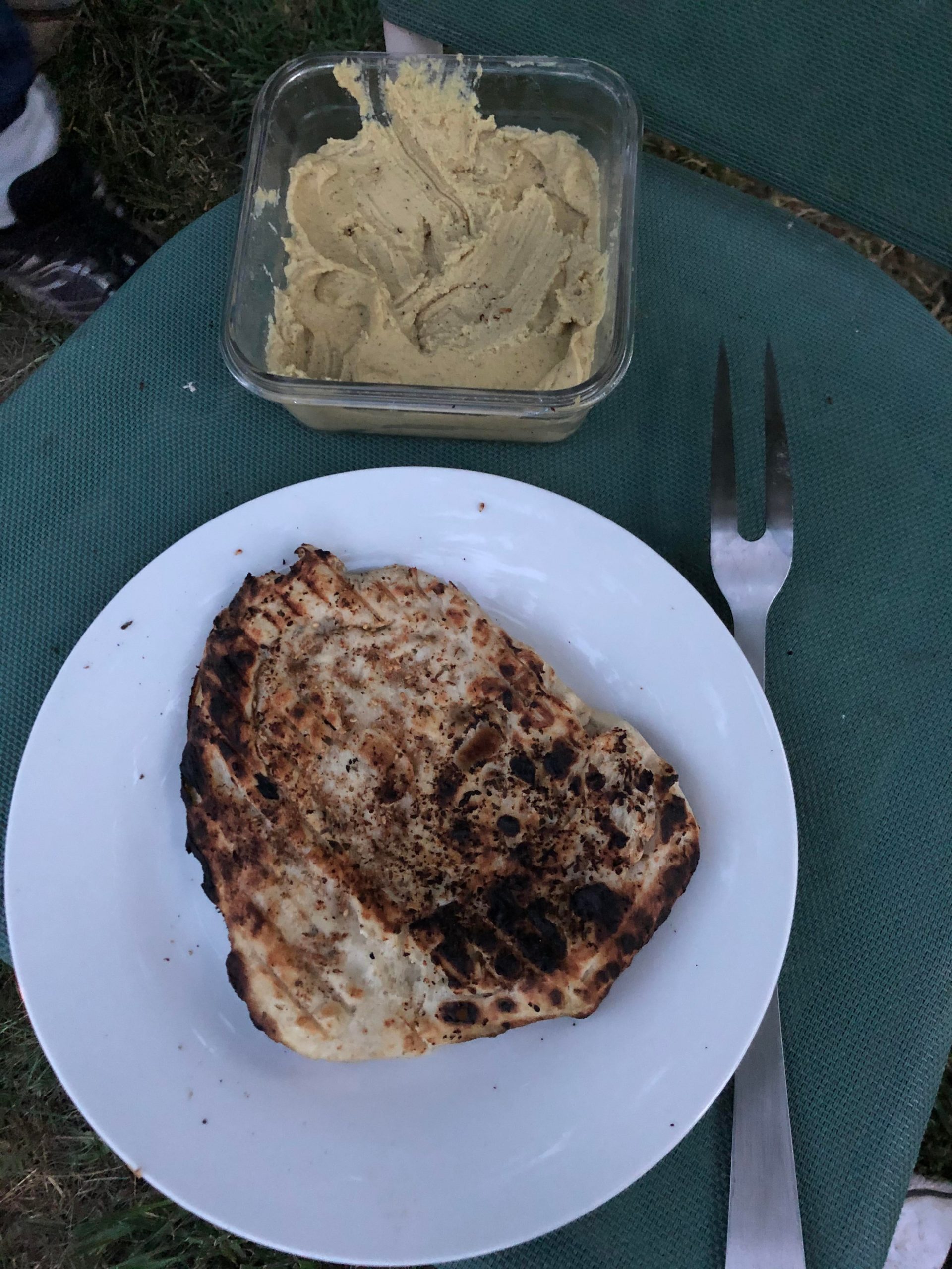 Za'atarseasoned flatbreads cooked over a firepit, roasted zucchini
