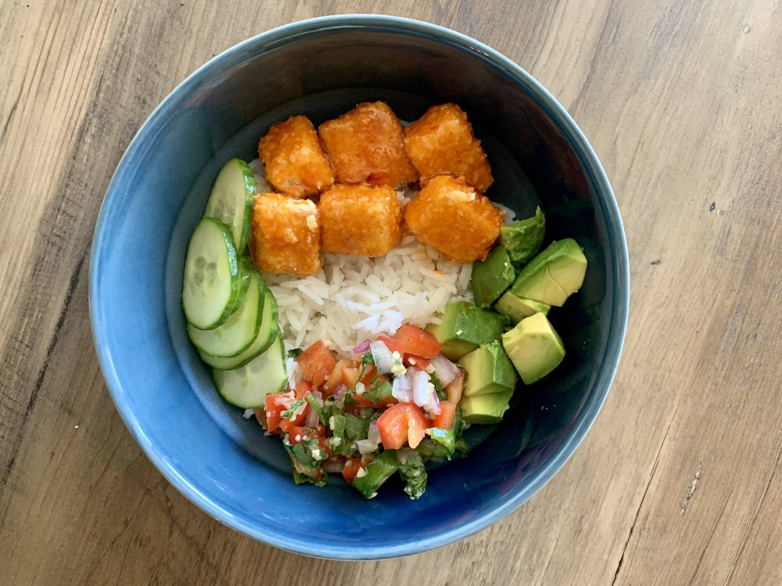 Crispy sweet chili tofu with basmati rice, cucumbers, salsa and avocado