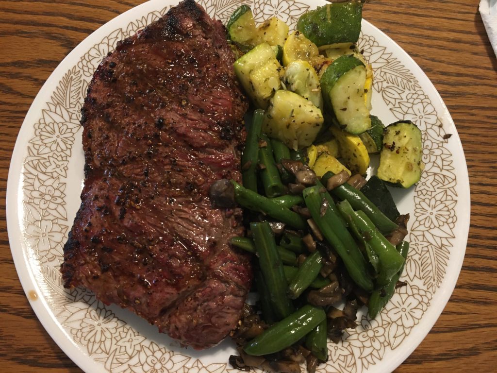 New York Strip on my Weber kettle with some summer vegetables. An excellent Sunday dinner.