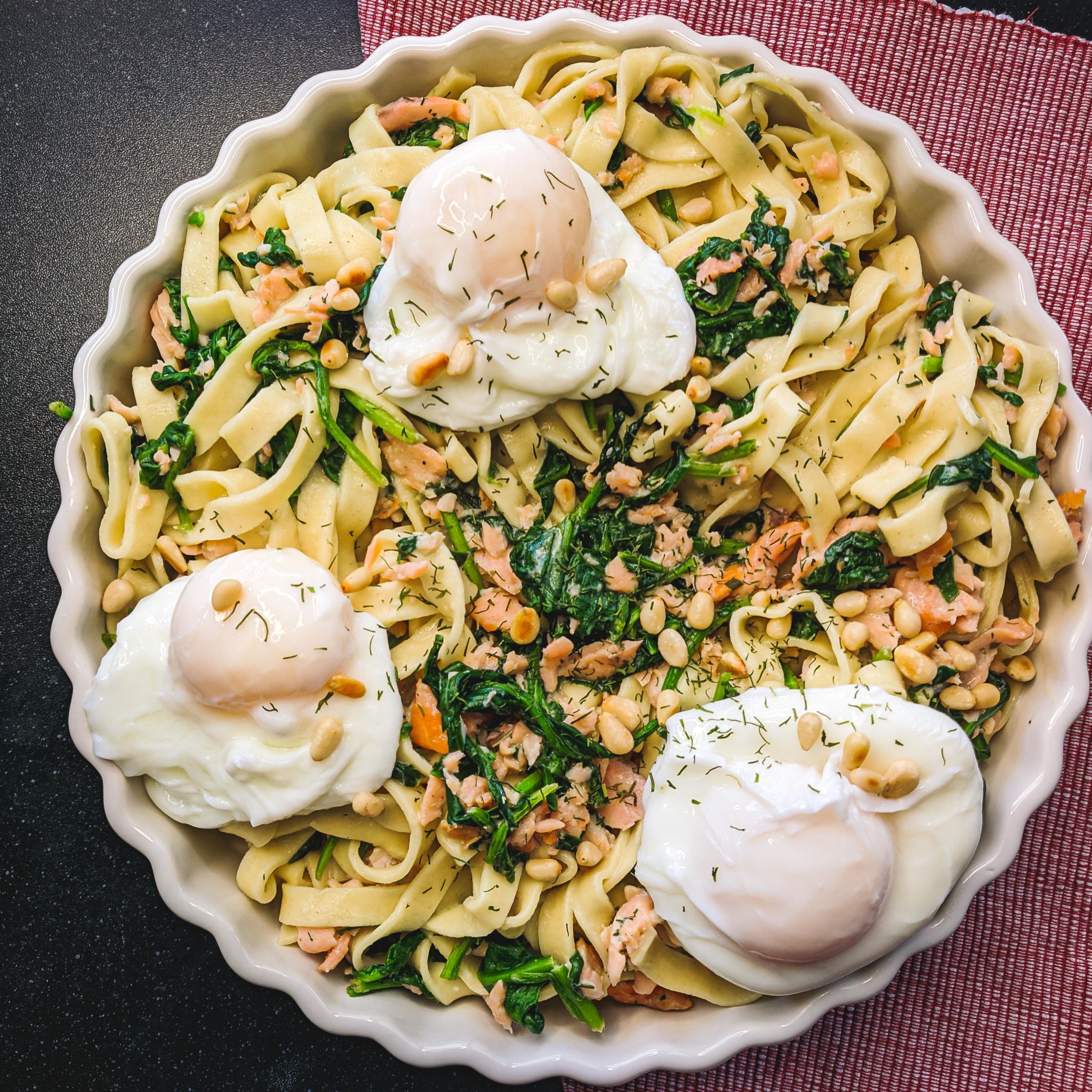 Fresh tagliatelle with salmon, spinach, boursin, pinenuts and a poached