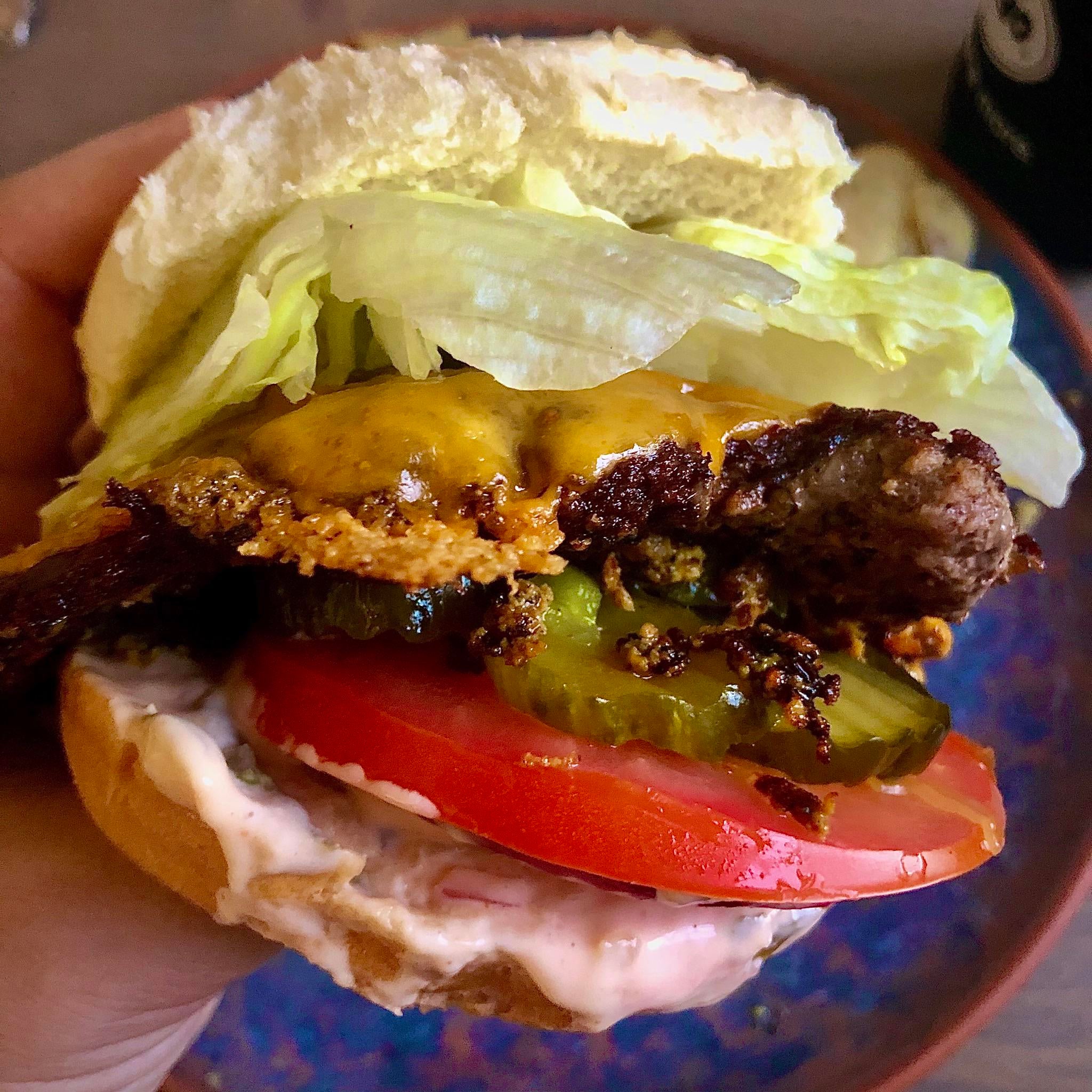 Smash burger, pickles, tomato, lettuce, onion, cheddar. Dining and