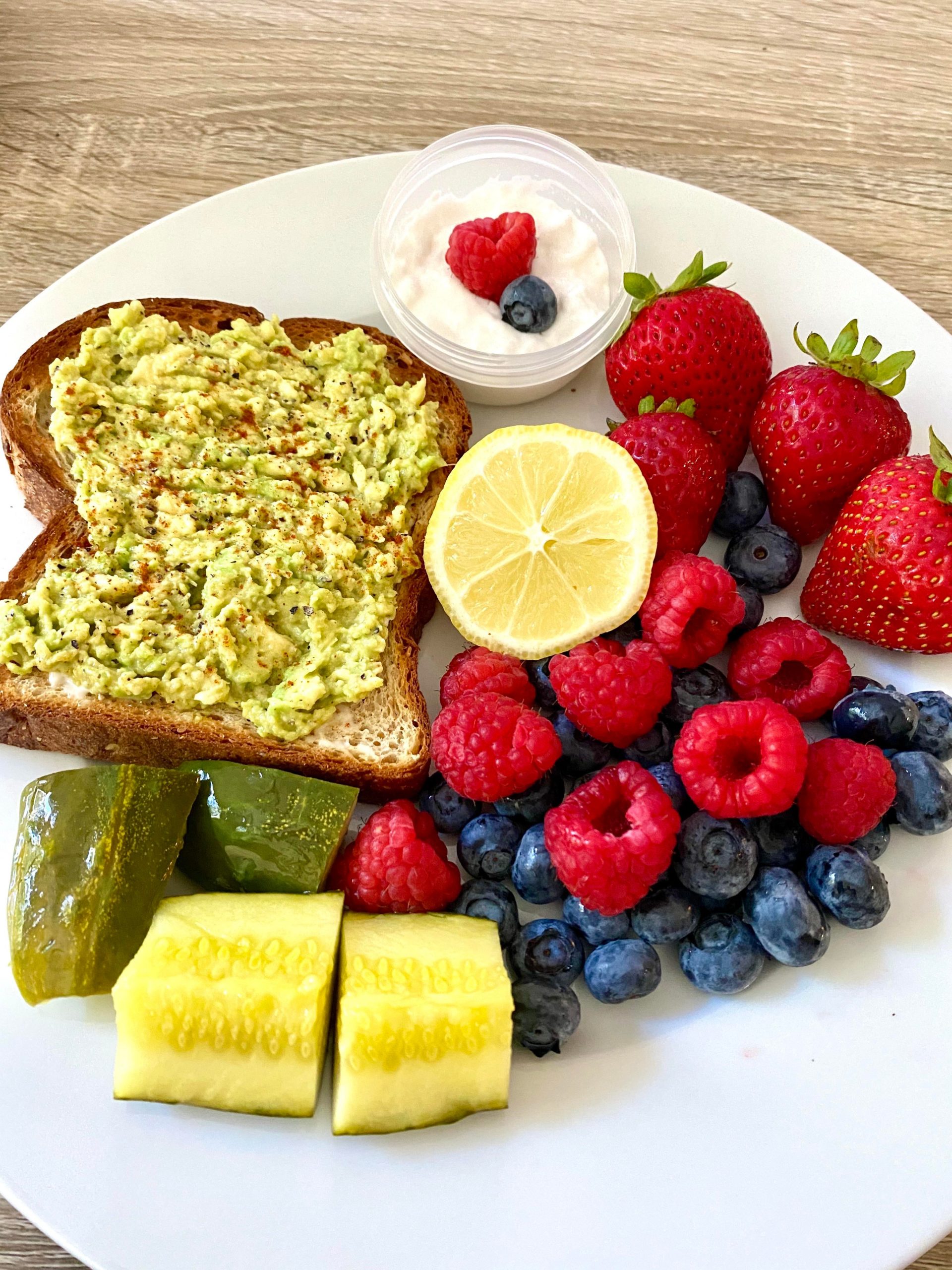 Avo toast, berries with marshmallow fluff and a pickle for breakfast