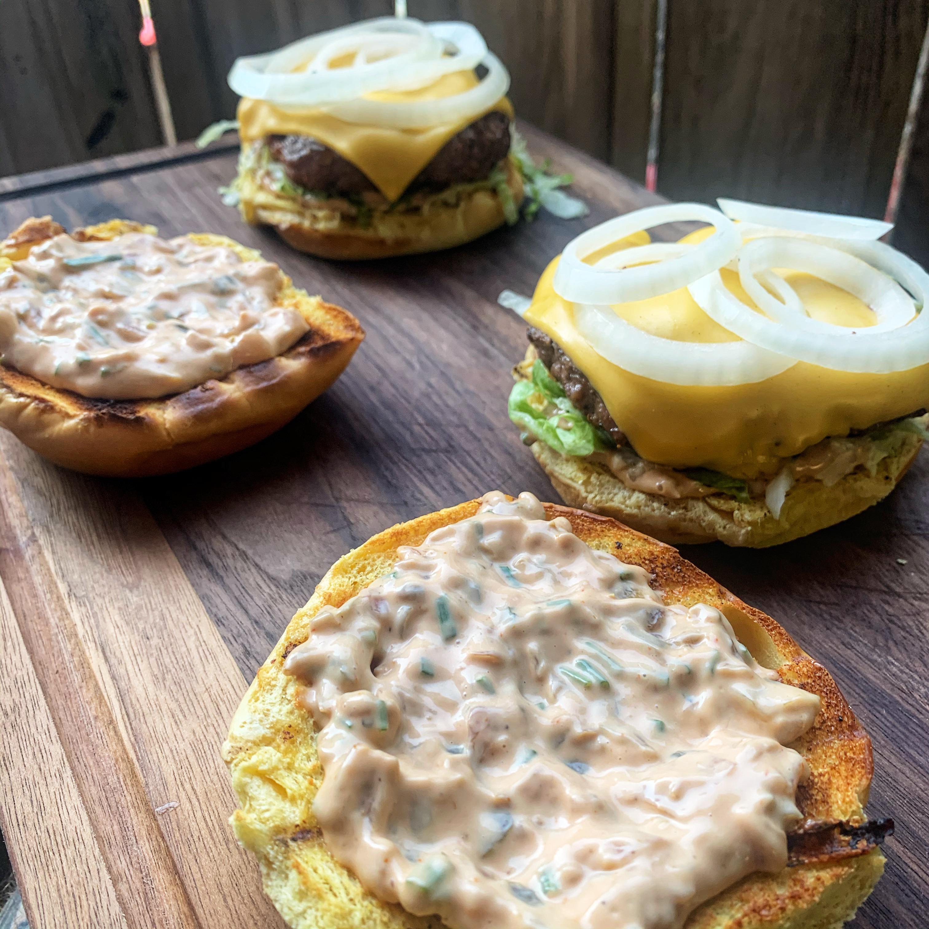 Cooked over charcoal w/ toasted brioche buns & homemade spread 🤯