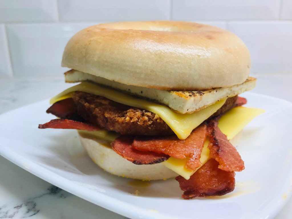 Breakfast bagel with chao cheese, lightlife bacon, hash brown patty and tofu.