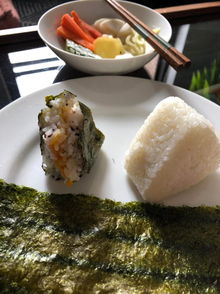 Onigiri with roasted nori (Dashi-braised Kobocha squash seasoned; ume shiso onigiri); Assorted nukazuke pickles.