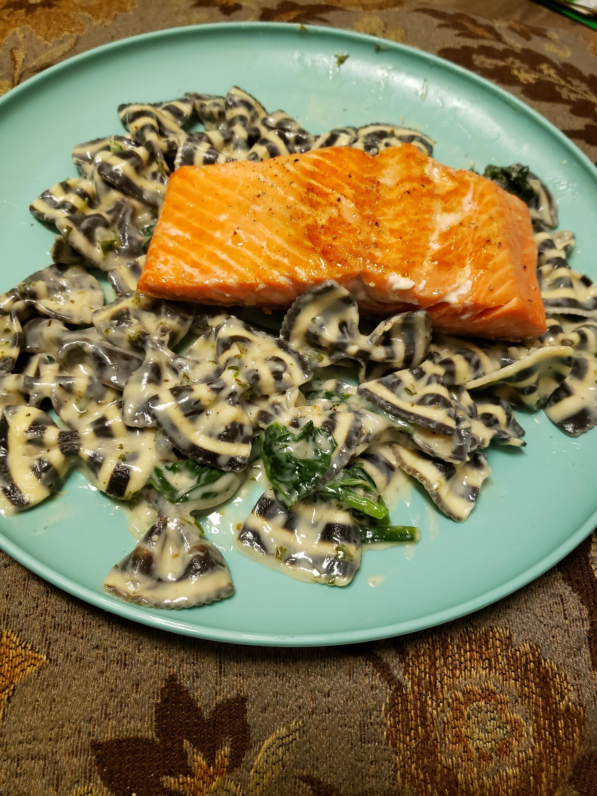 My bf made me pan seared salmon on striped farfalle alfredo pasta for