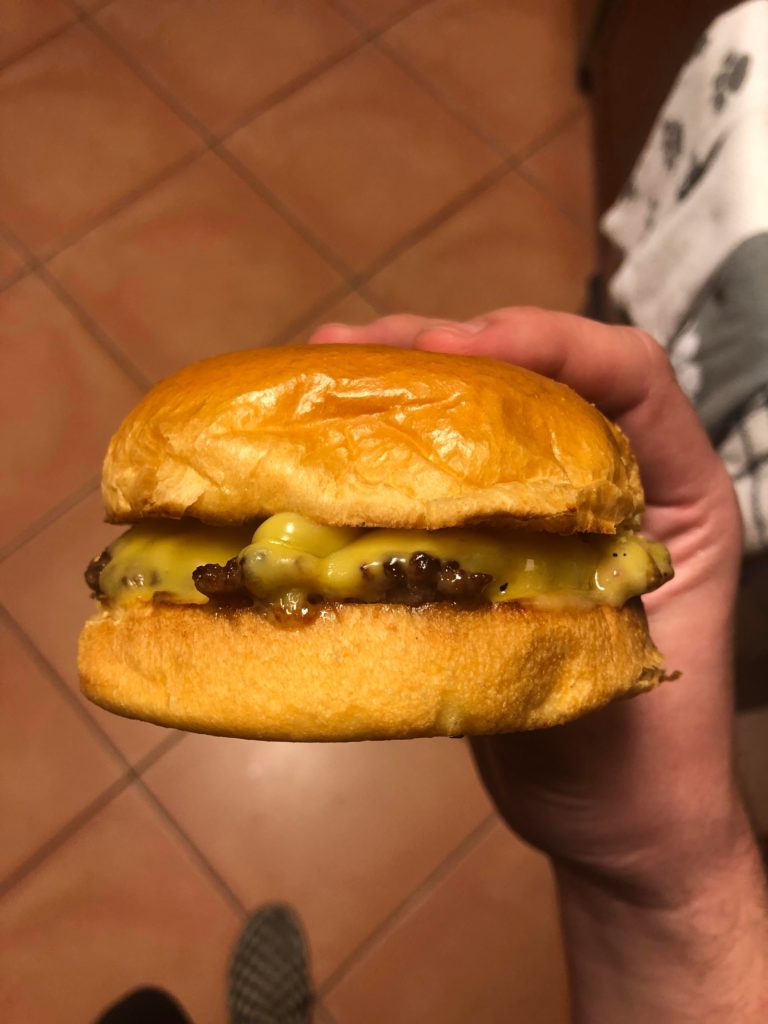 Smash burger with melty American cheese.