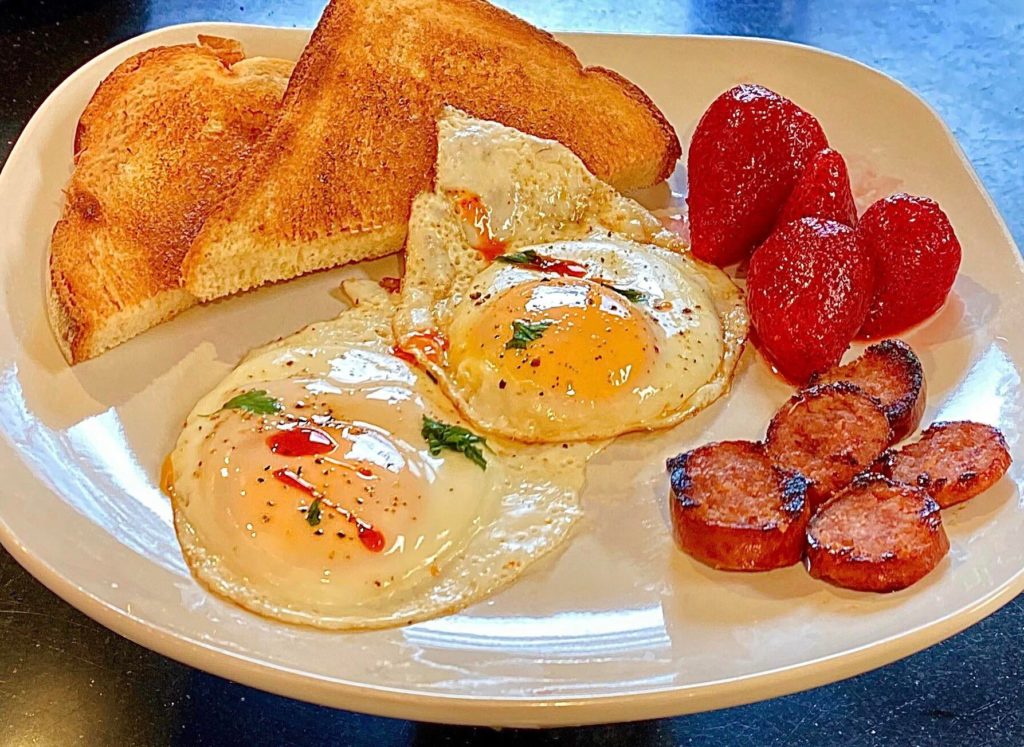 Eggs, sausage, toast and strawberries