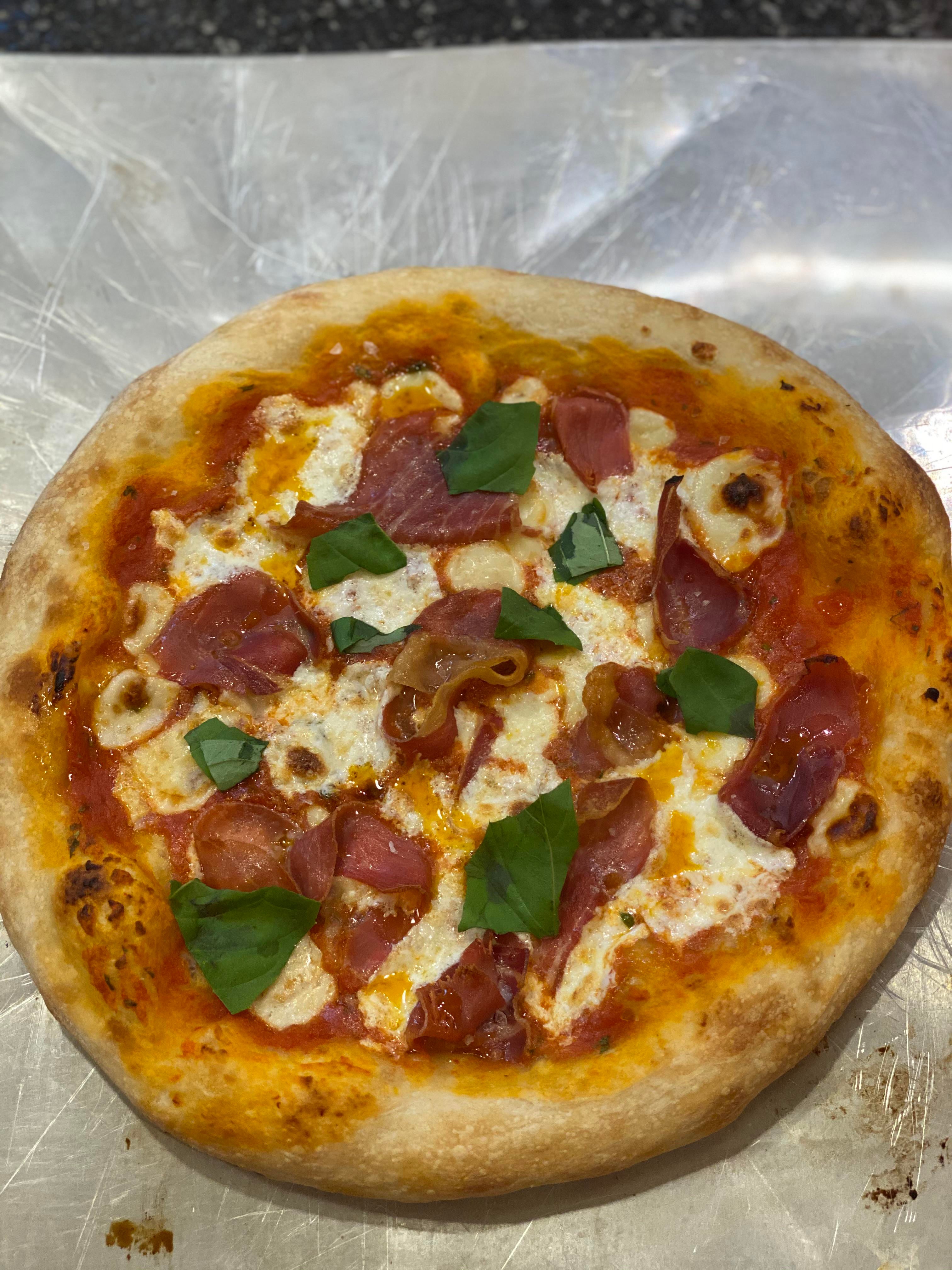 Napoli style pizza. Proscuitto, mozz, basil, hot oil ...
